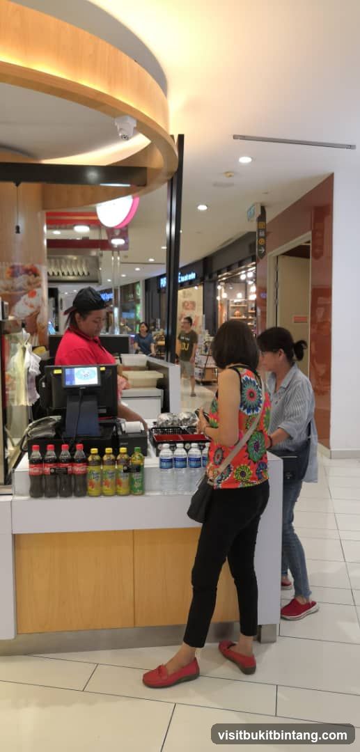 Customers at a food kiosk