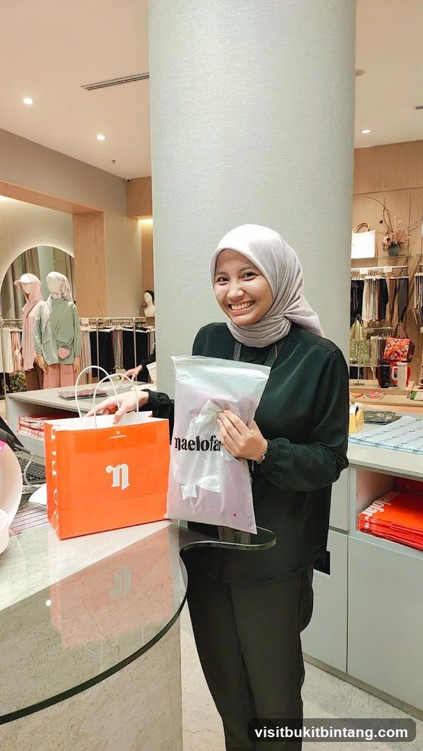 Woman holding shopping bag and garment bag