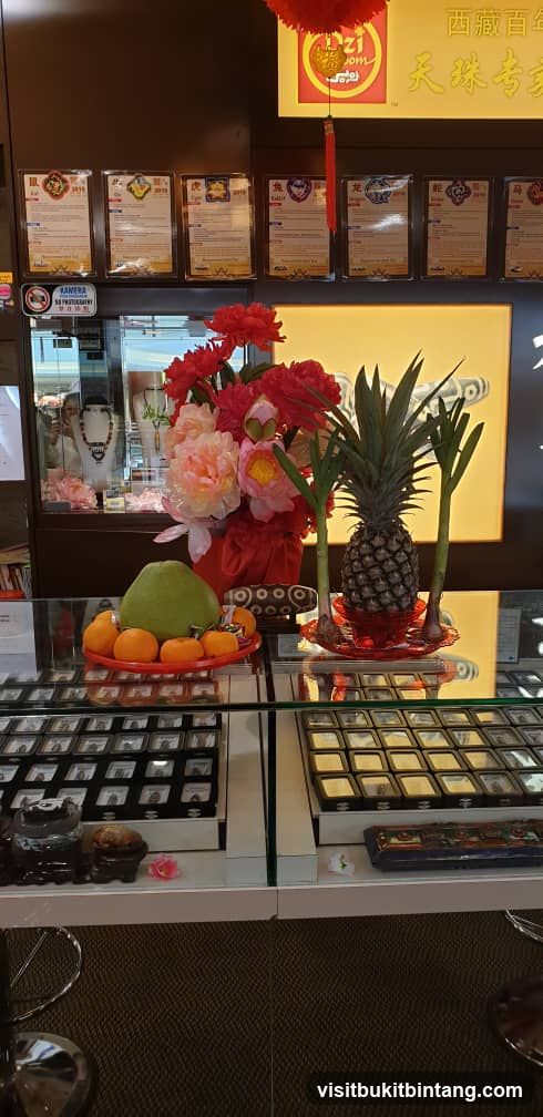 Jewelry store display with auspicious fruits and flowers