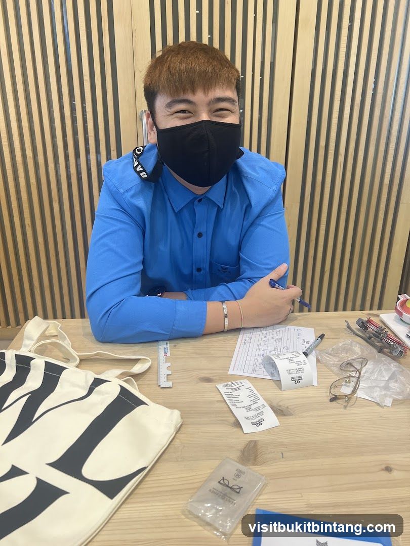 Man at a desk with a tote bag and receipts