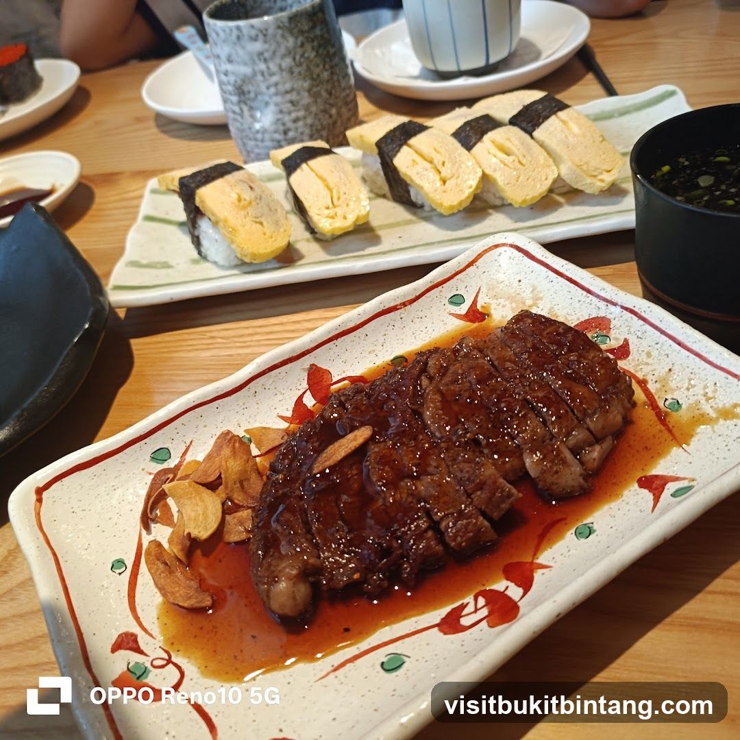 Sliced steak and sushi on a table