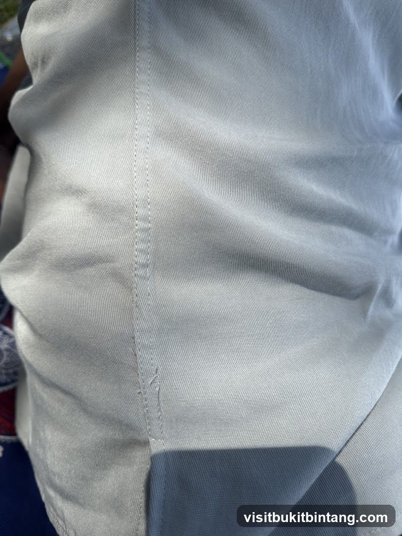 Close-up of light-colored fabric with stitching