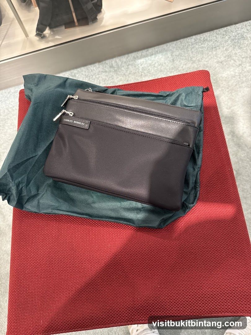 Black clutch bag with Charles Berkeley logo