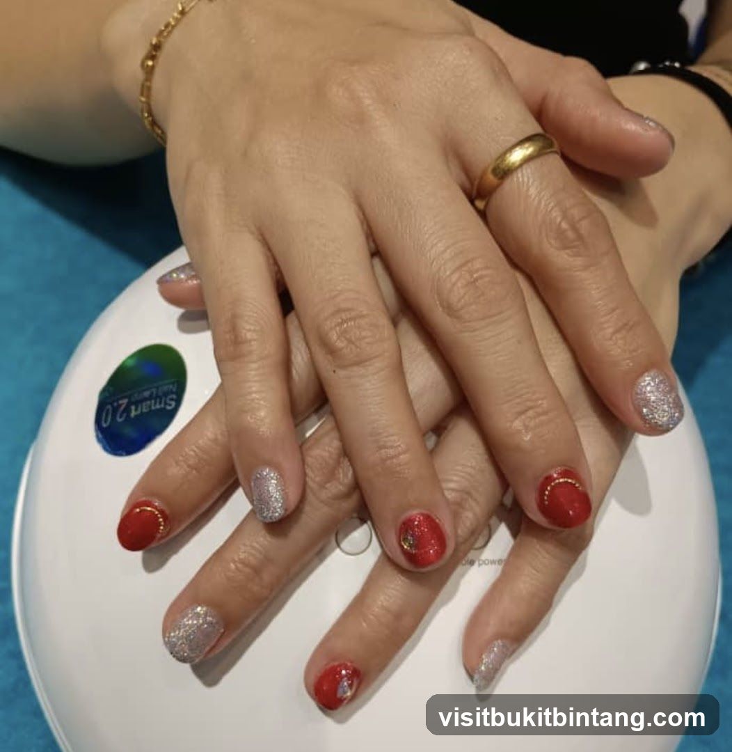 Manicured Hands with Red and Silver Glitter Polish