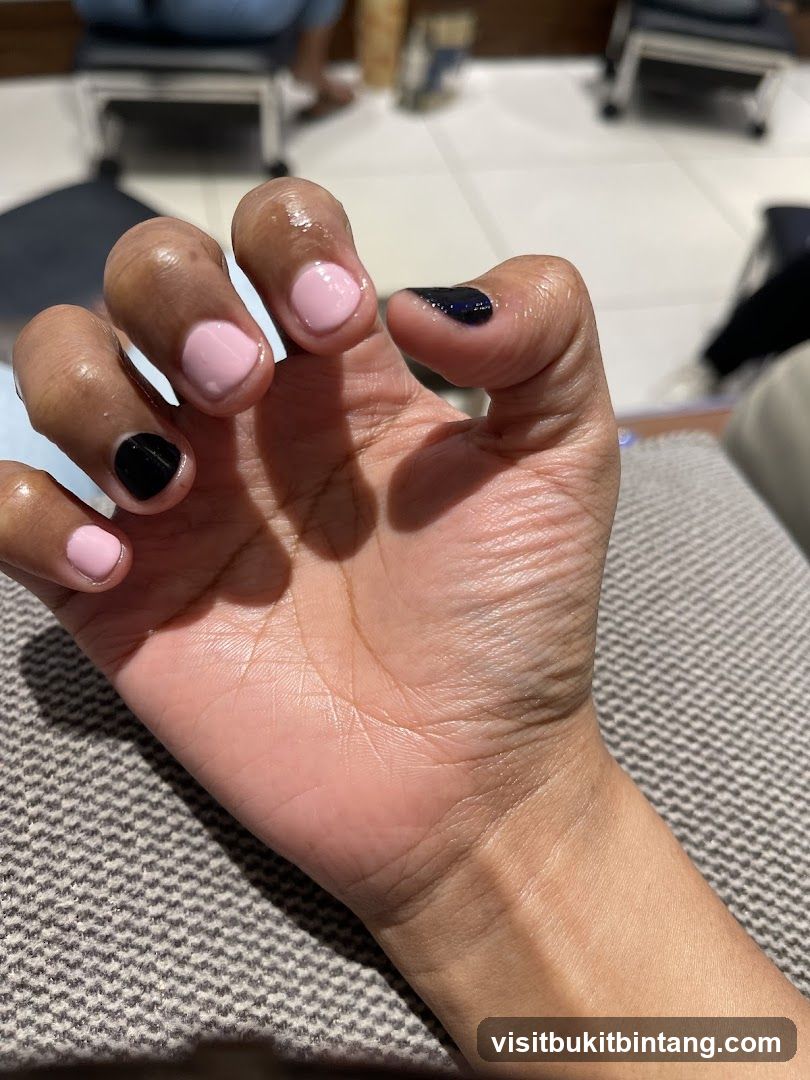 Manicured Hand with Pink and Black Polish