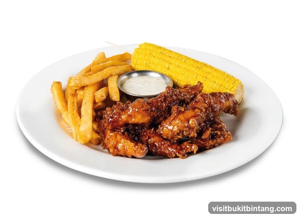 Chicken tenders with fries and corn on the cob