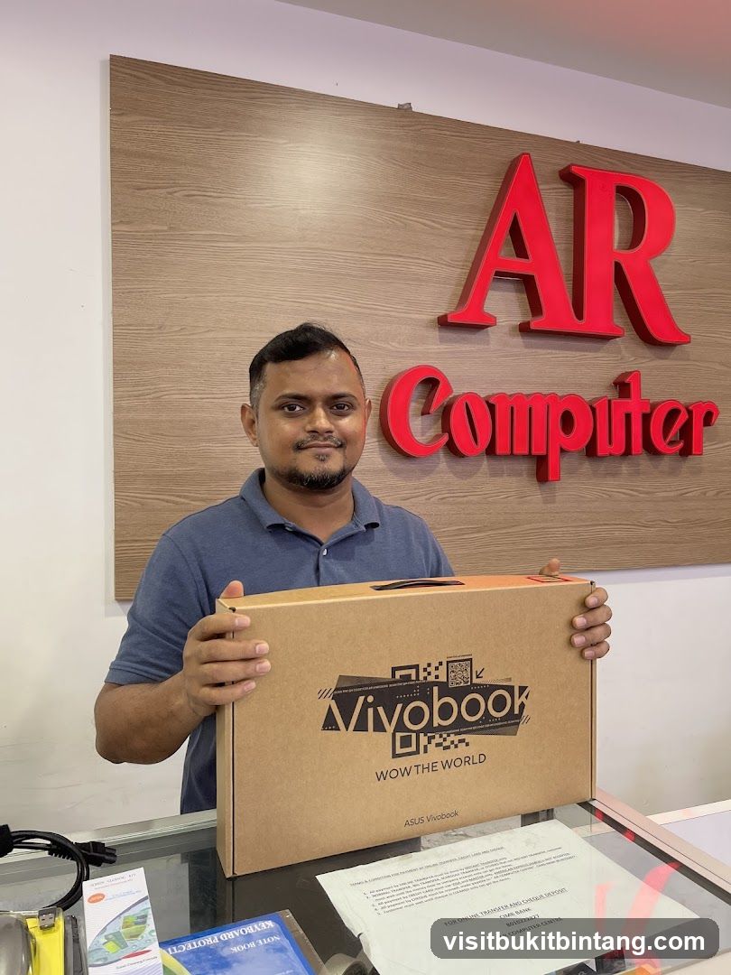 Man holding a Vivobook laptop box