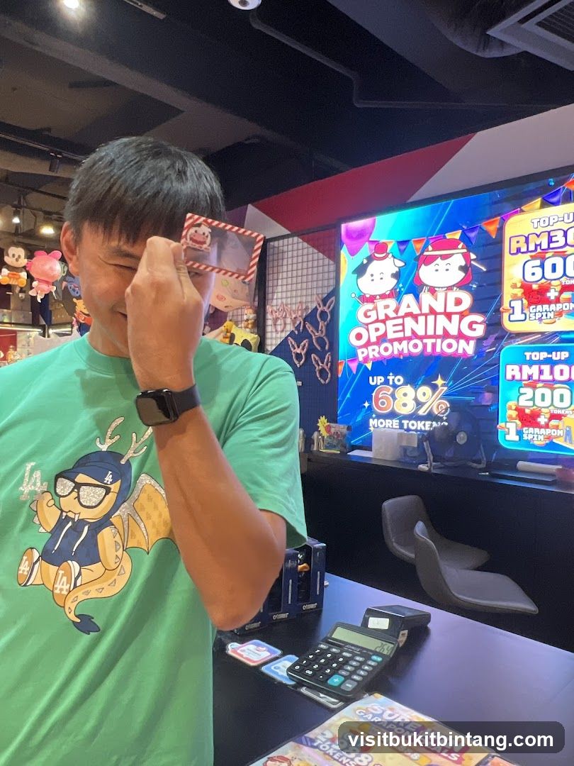 Man holding card near arcade screen