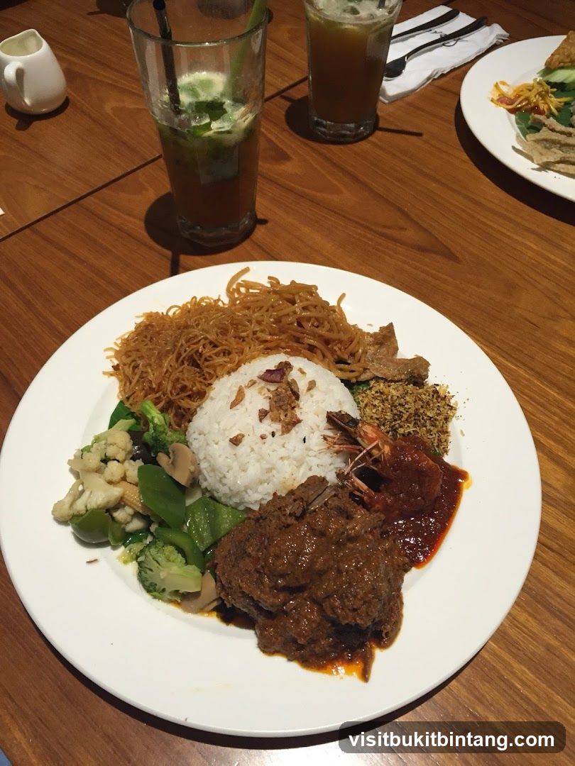 Plate of food with rice, meat, vegetables, and shrimp