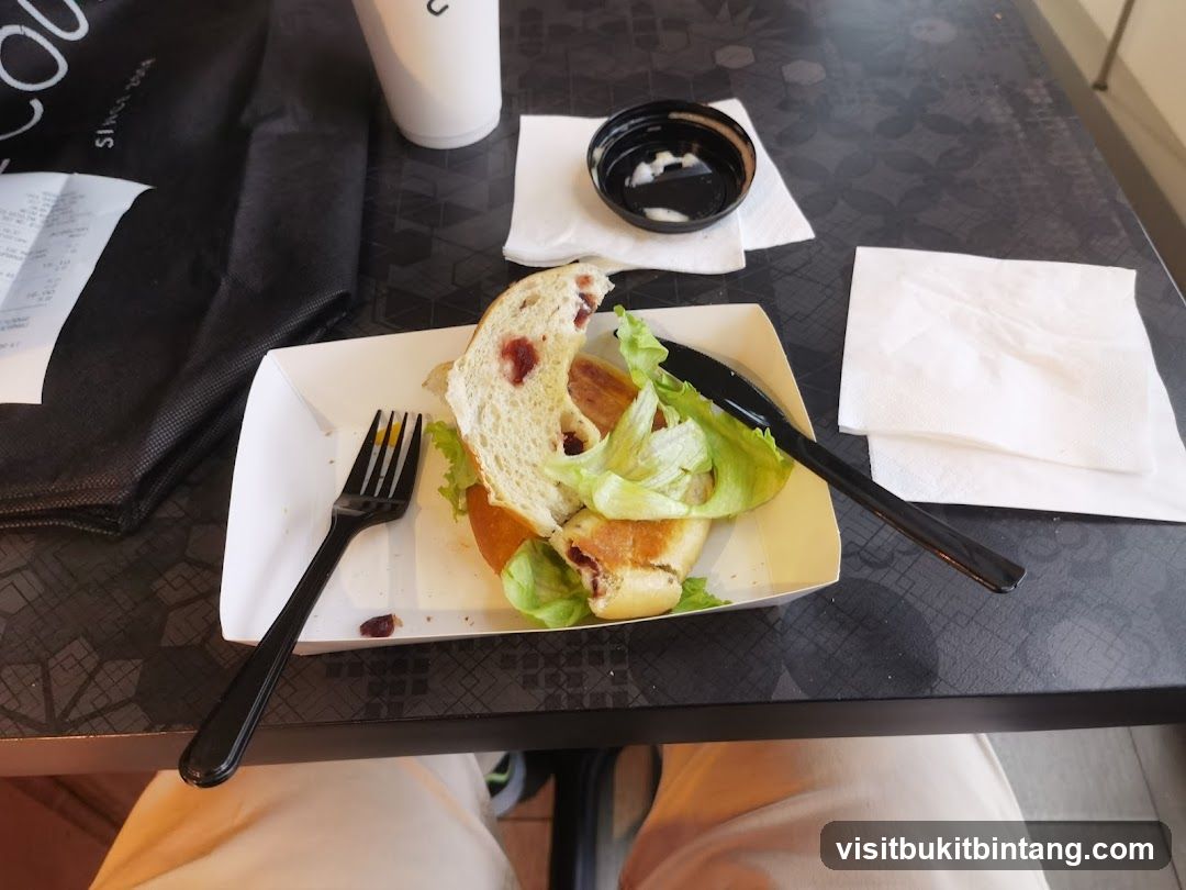 Half-eaten sandwich on a tray