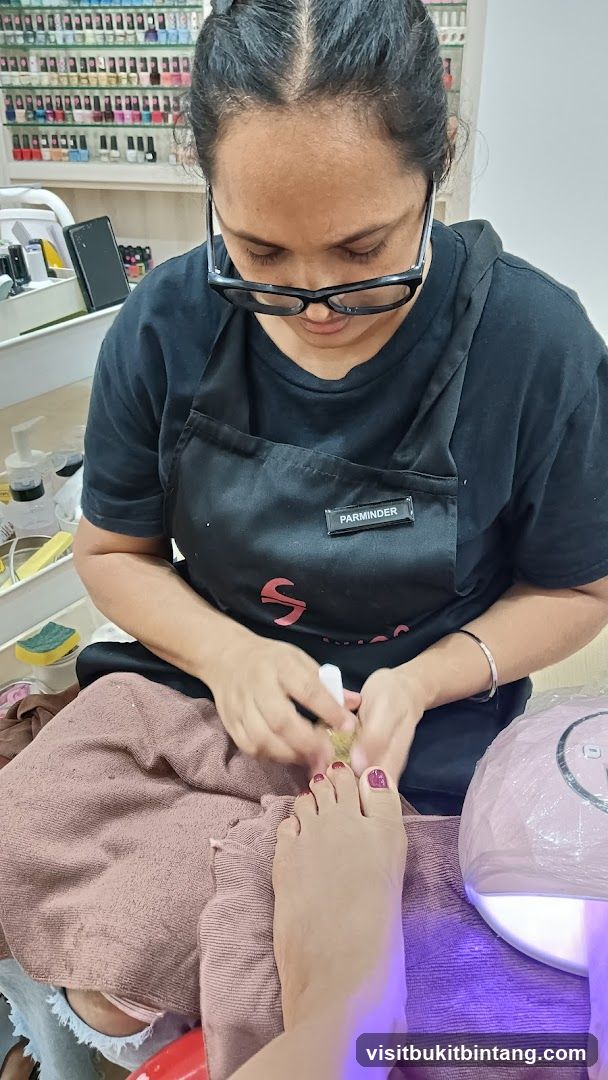 Nail Technician Performing Pedicure