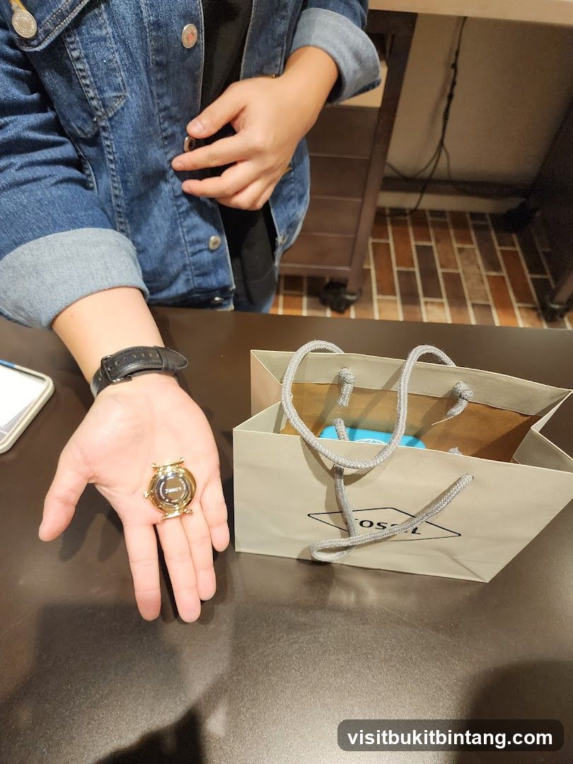 Person holding a watch with a shopping bag