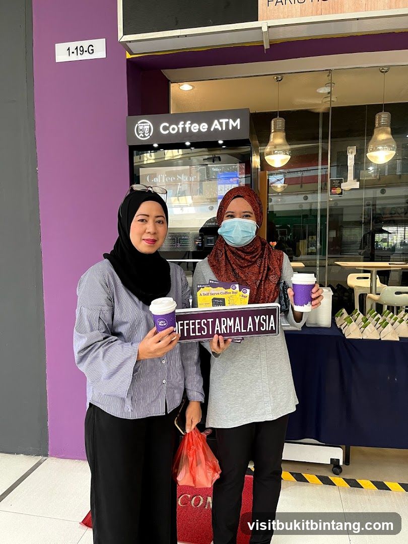 Two women holding coffee cups and a sign