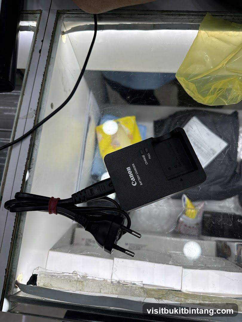 Canon Battery Charger on Glass Display Case