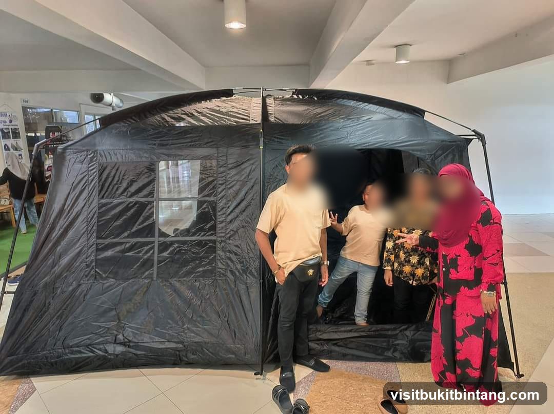 People posing in front of a large black tent