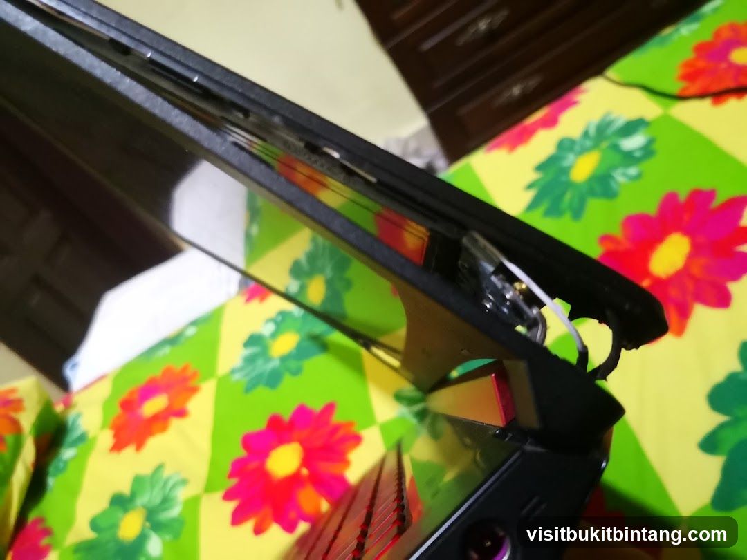 Open Laptop on Floral Bedspread