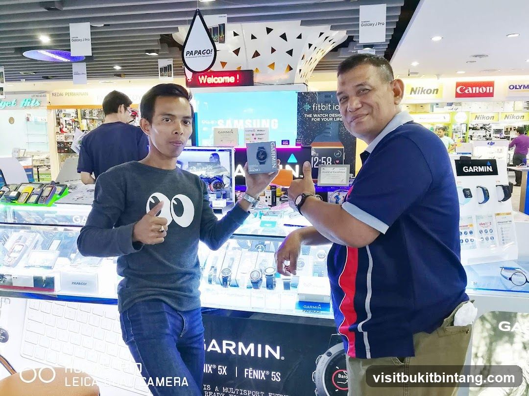 Electronics Store Interior with Staff Displaying Products