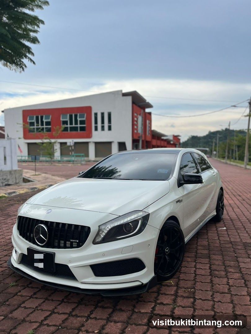 White Mercedes-Benz A-Class parked on brick pavement