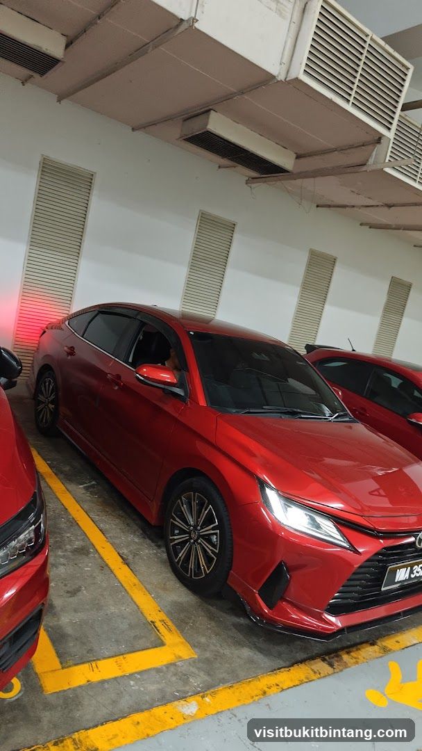 Red Sedan in Parking Garage