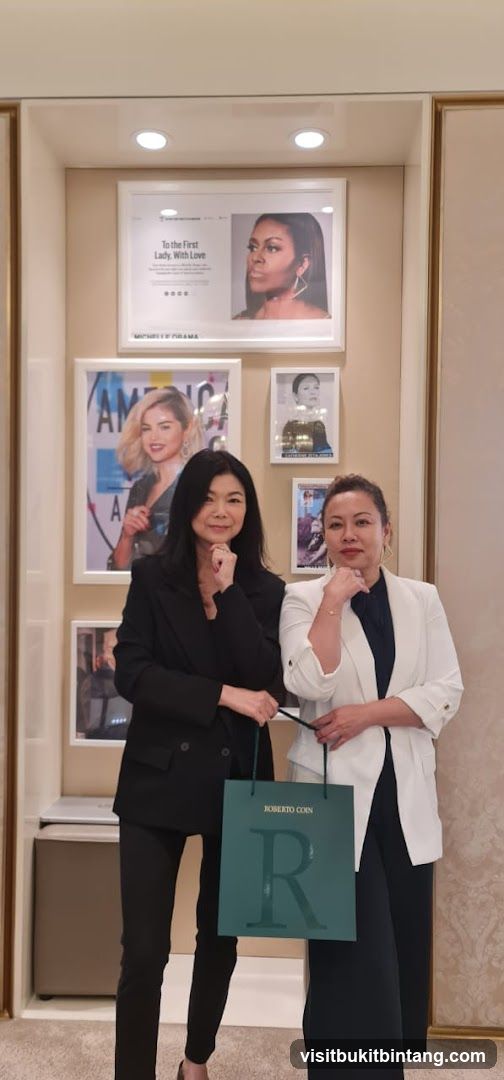 Two women posing with shopping bag in store interior