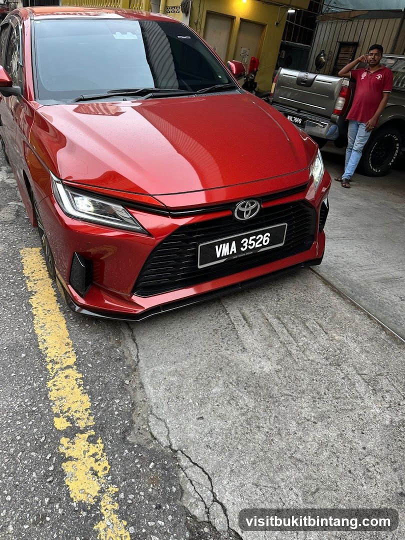 Red Toyota Corolla Altis parked outside shop
