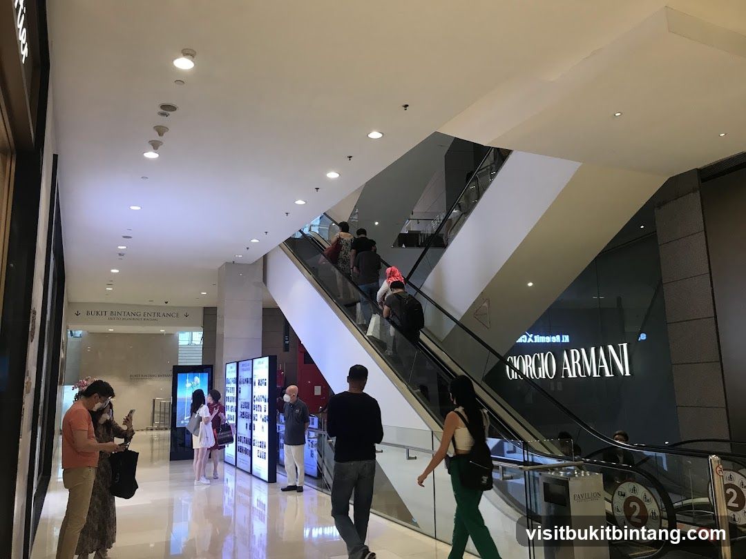 Shopping Mall Interior with Escalators and Storefronts
