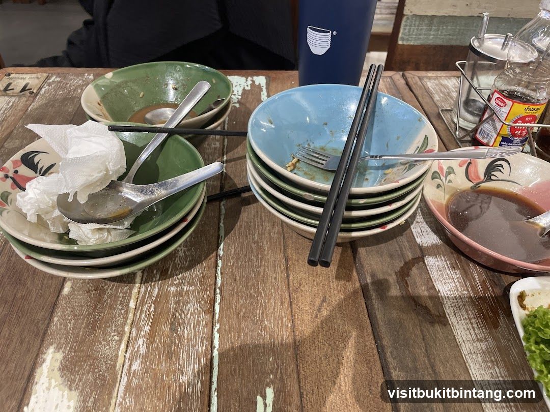 Used Bowls and Utensils on Wooden Table
