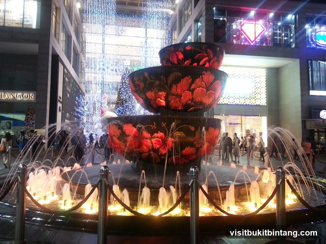 Fountain with illuminated bowls and water jets at night