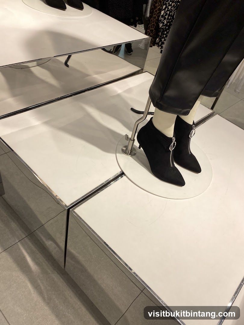 Mannequin wearing black boots and pants