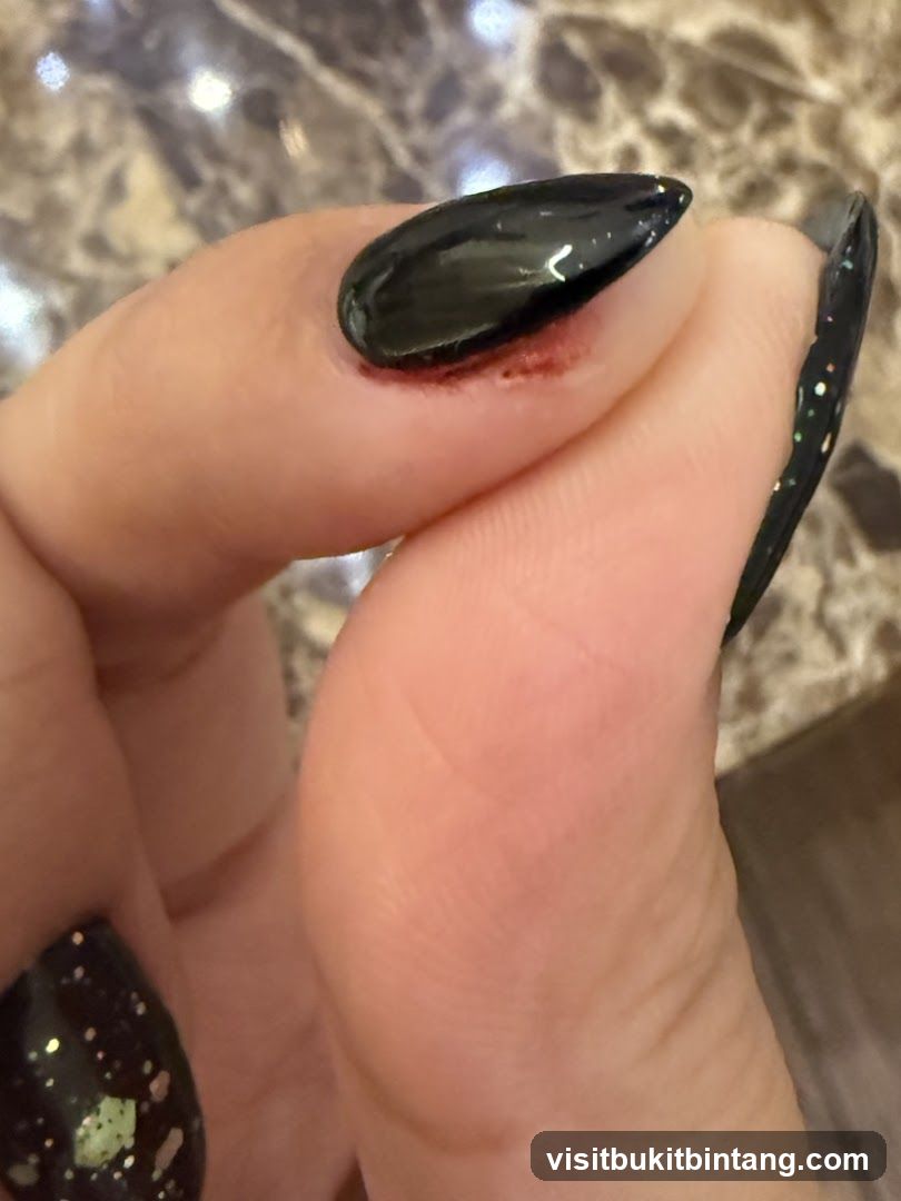 Close-up of a person's hand with black nail polish