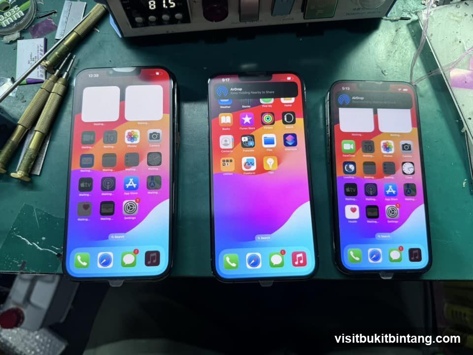 Three iPhones on a workbench
