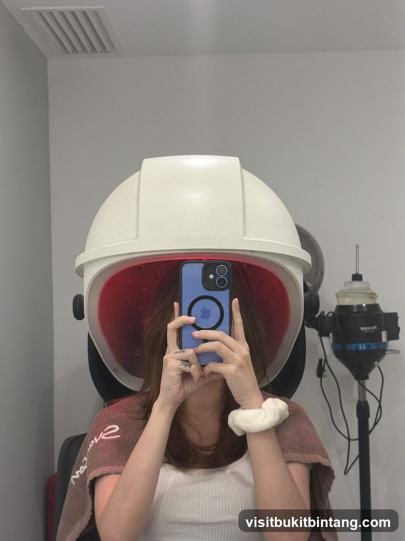 Woman under hair steamer