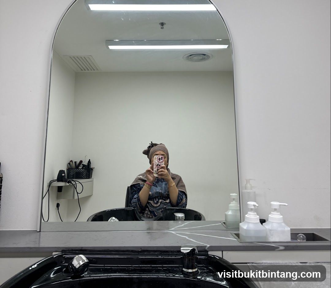 Woman taking a selfie in a salon mirror