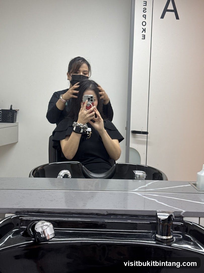 Hairdresser styling client's hair