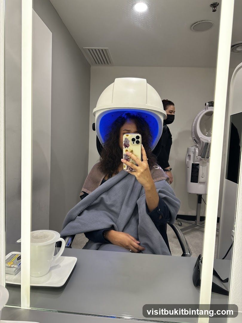 Woman under a hair steamer