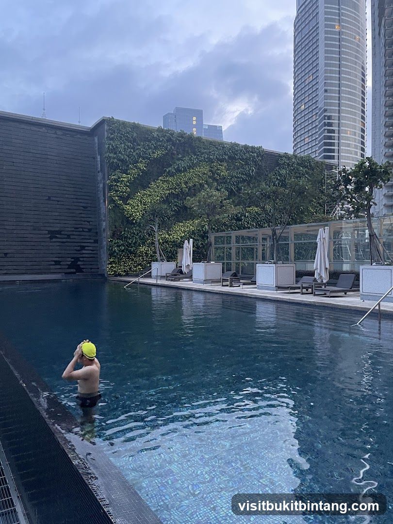 Man in Swimming Pool with Cityscape Background