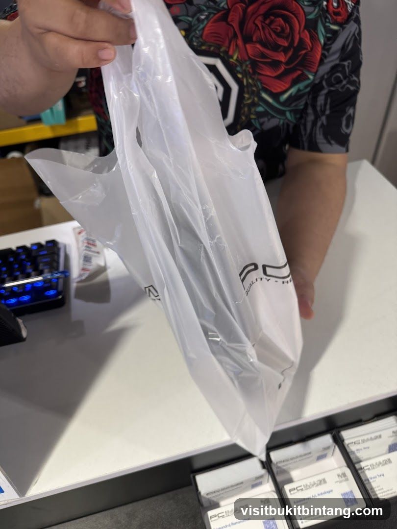 Person holding a plastic bag with a logo