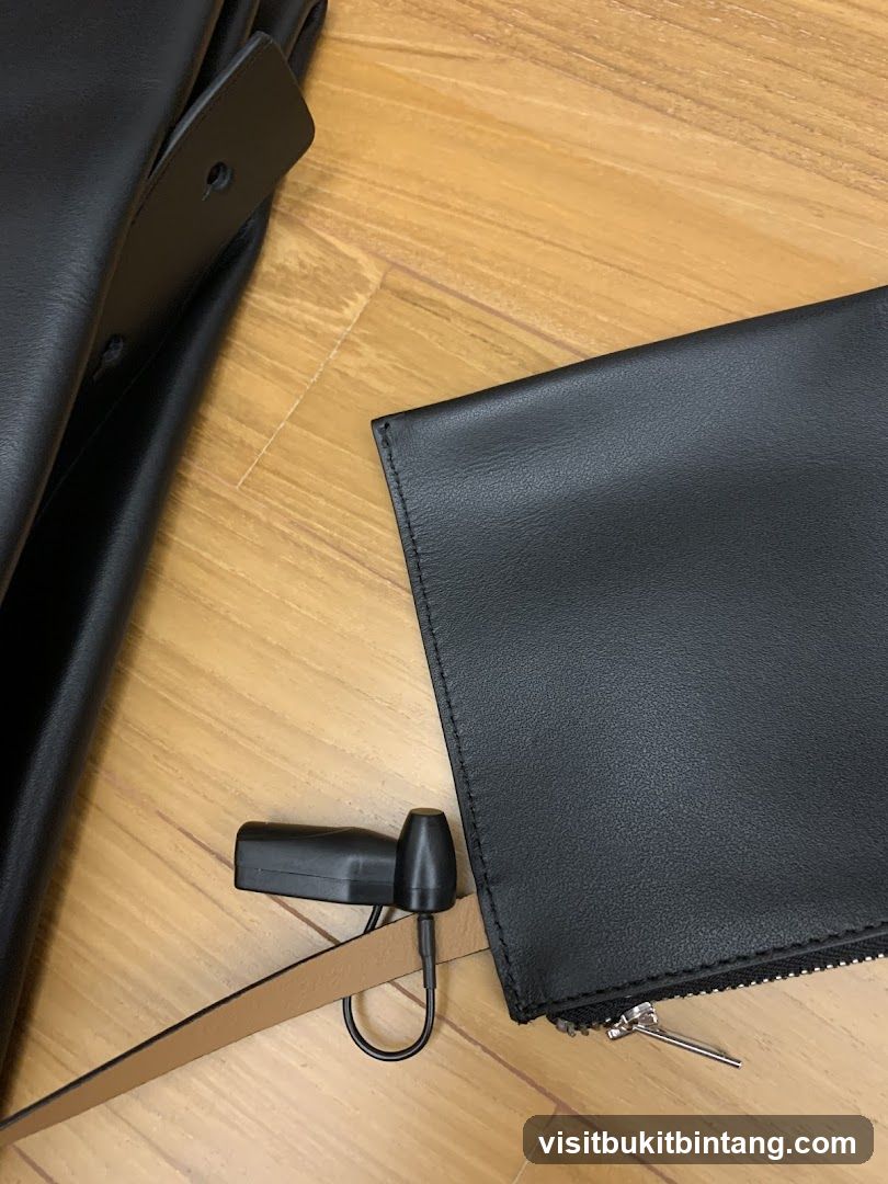 Black Leather Wallet and Strap on Wooden Floor
