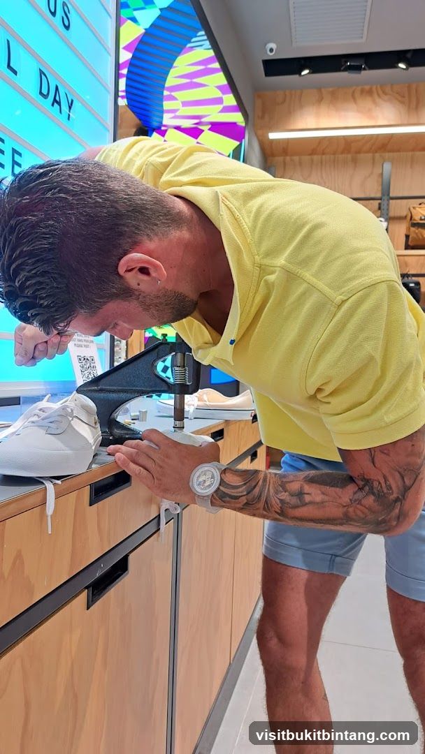 Man using a shoe-lace eyelet press