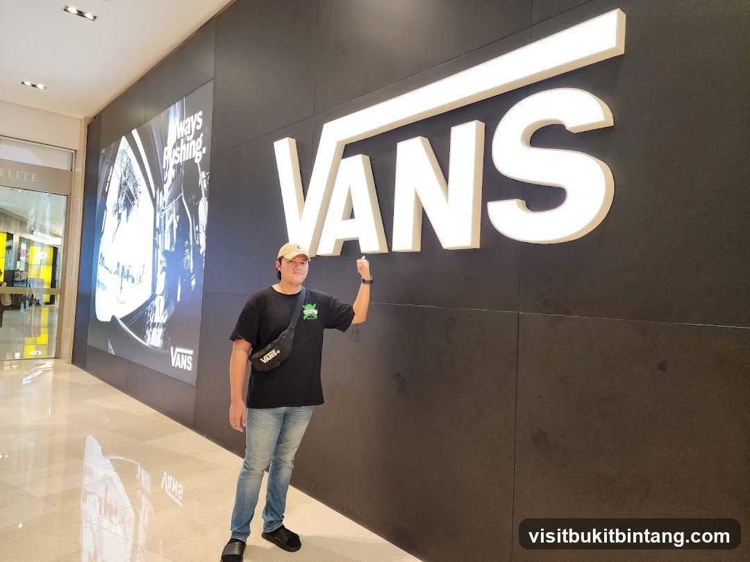 Man Posing in Front of Vans Store Sign