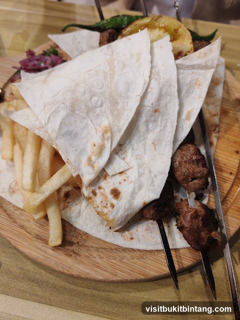 Meat skewers with flatbread and fries