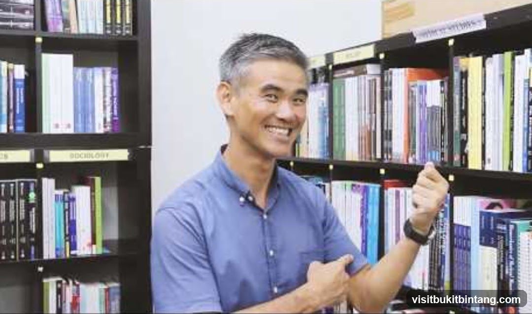 Man in front of bookshelves