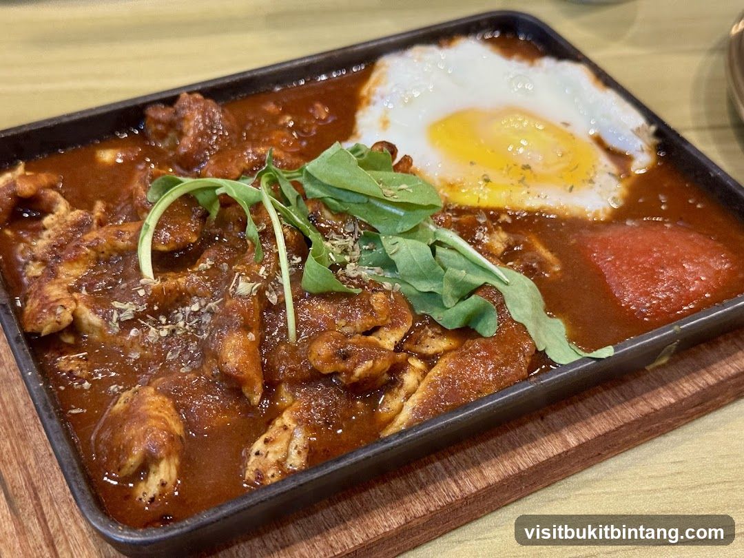 Sizzling Chicken Dish with Fried Egg