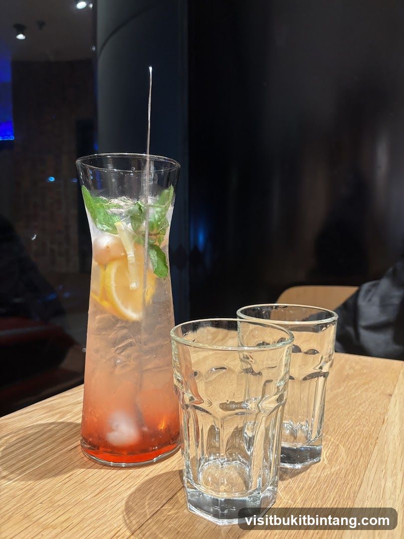 Pitcher of pink drink with lemon and mint
