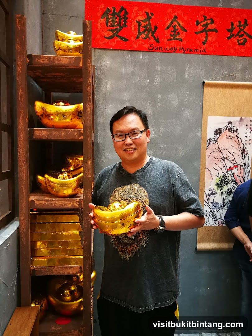Man holding gold ingot decoration