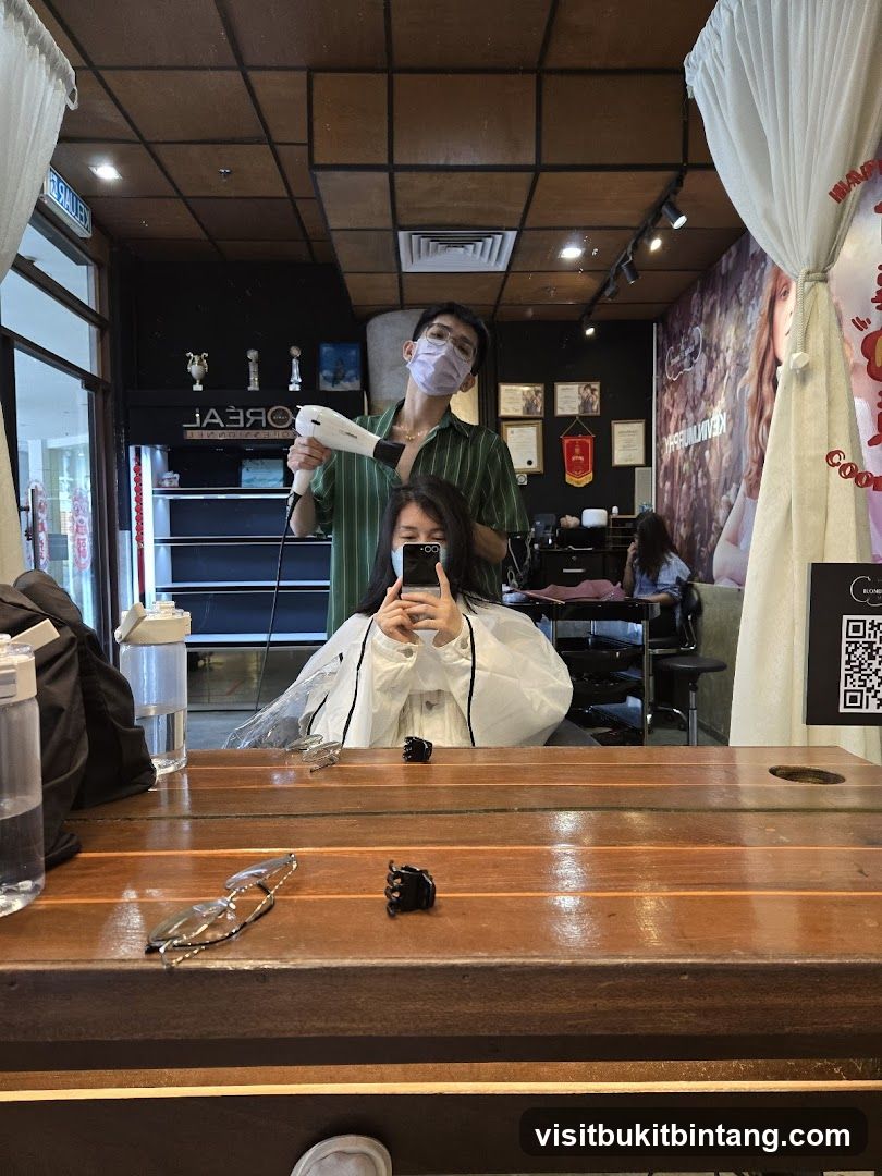 Hairdresser drying client's hair