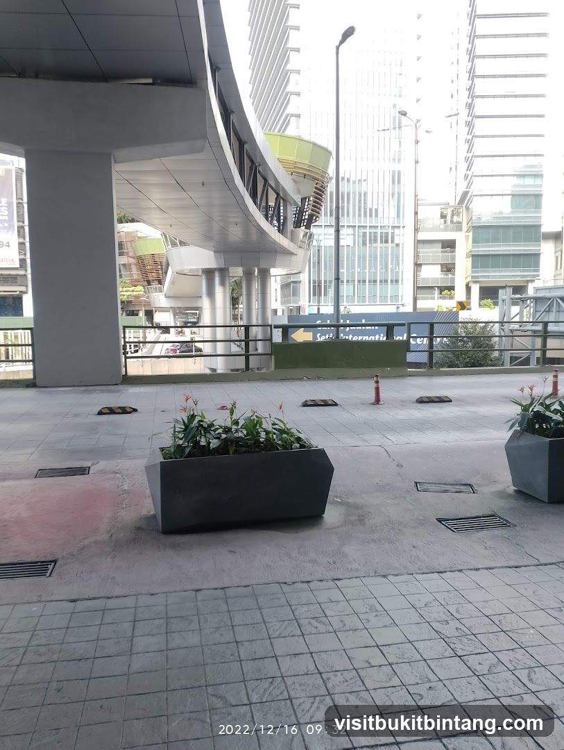 Urban walkway with planters and buildings