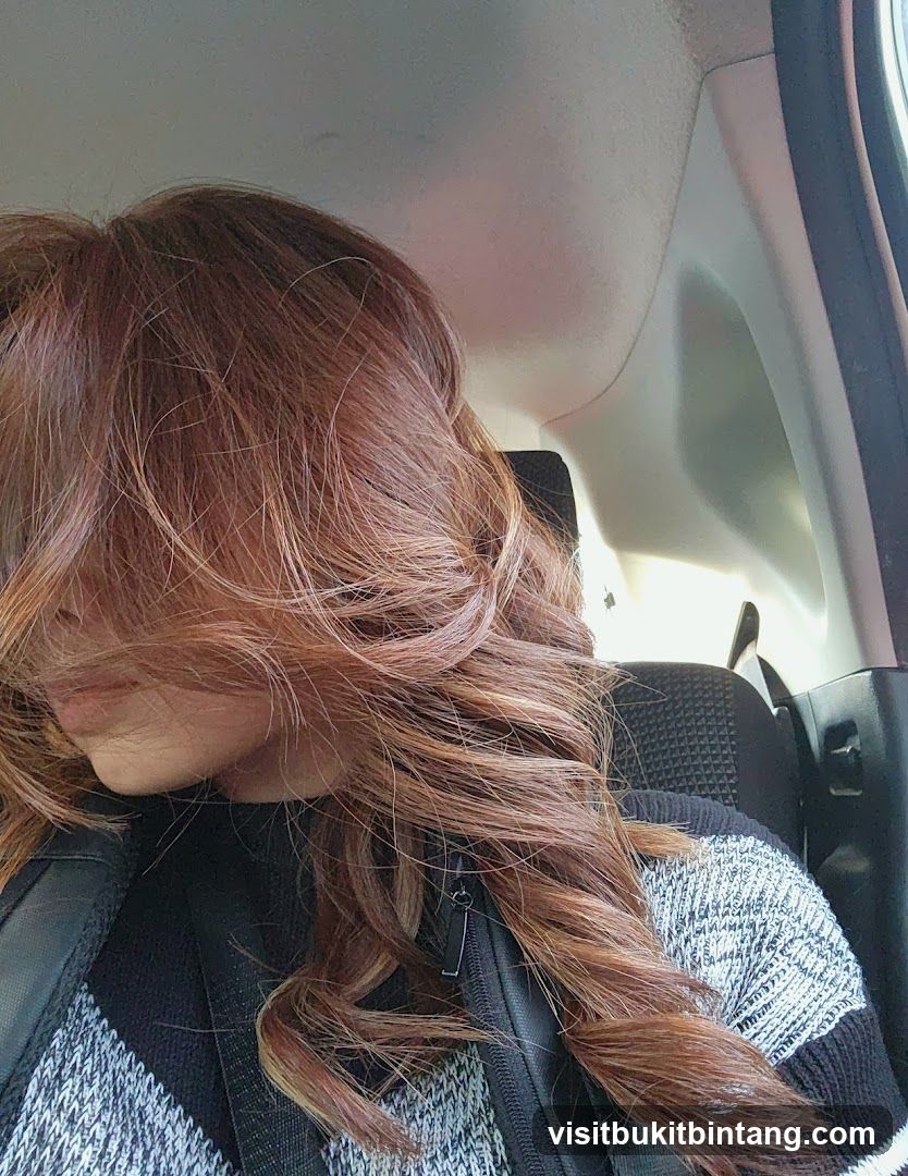 Woman with long, wavy, reddish-brown hair