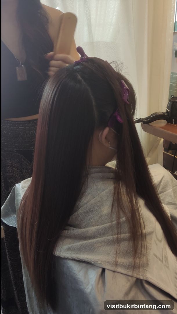 Hairdresser styling client's hair