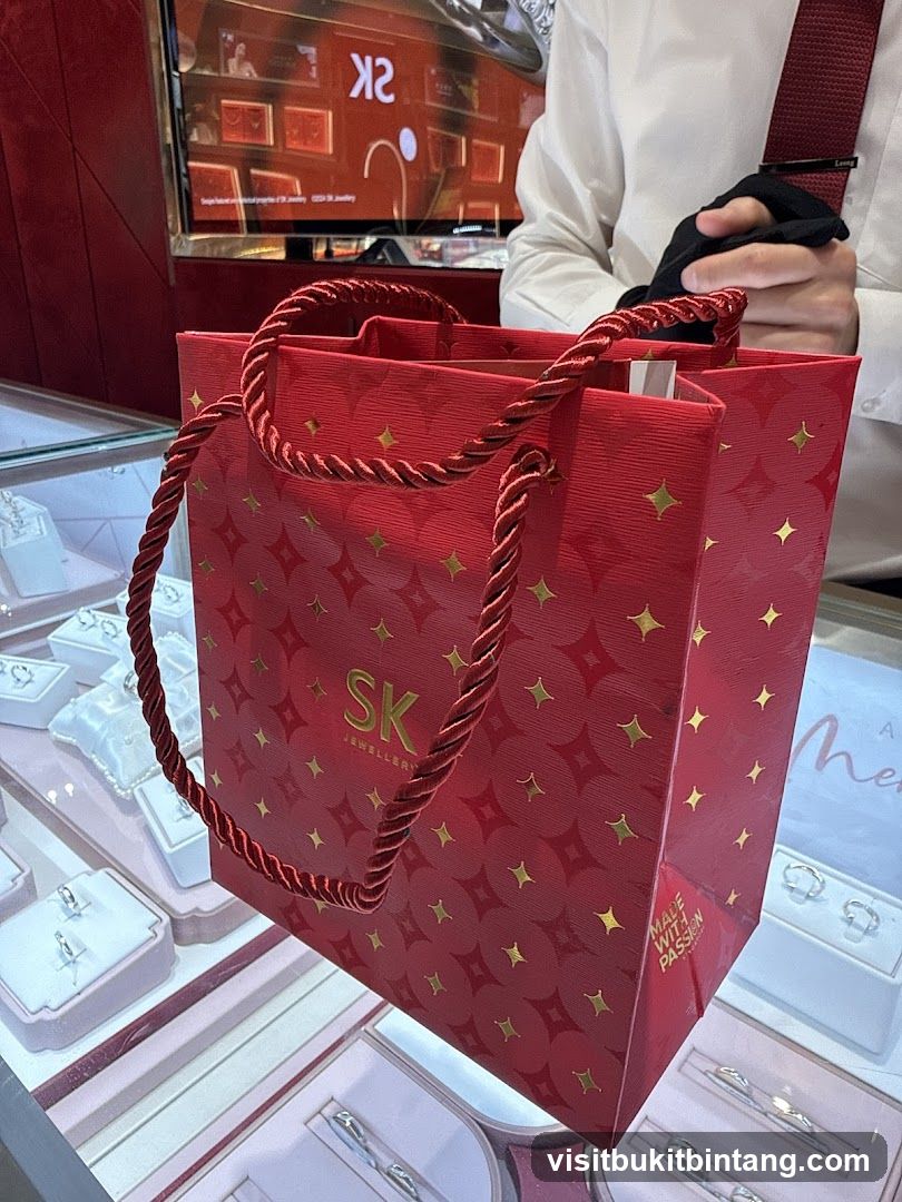 Red shopping bag with gold star pattern and SK JEWELLERY logo